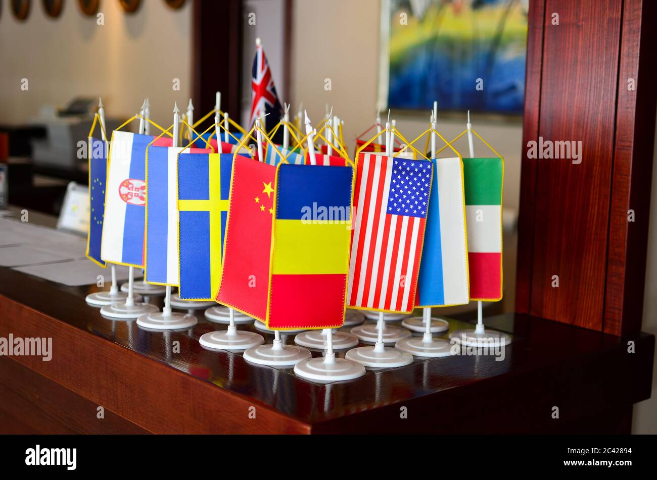 Little flags of different counties on the reception desk in a hotel Stock Photo