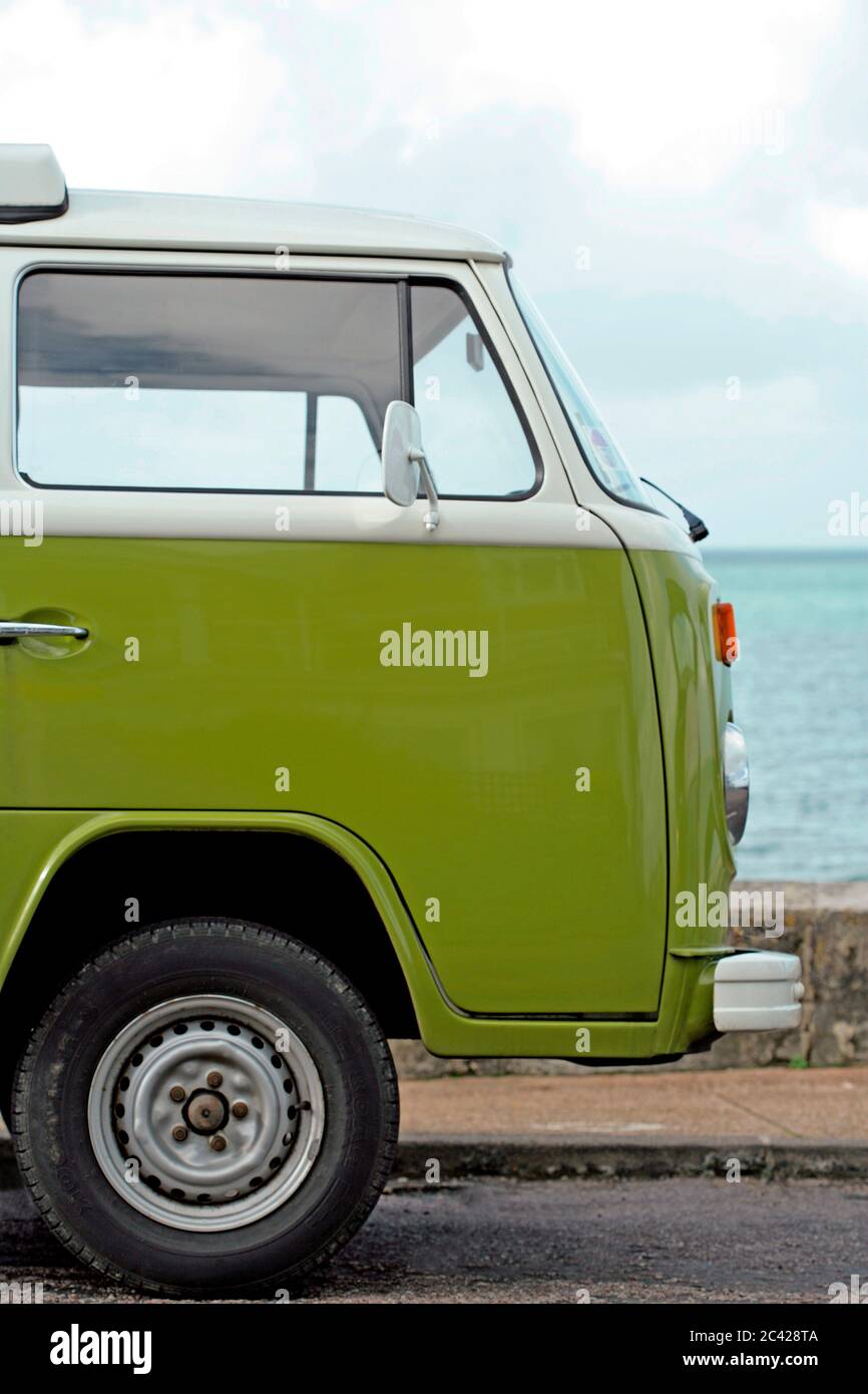 Green delivery van, camper parked on the beach Stock Photo - Alamy