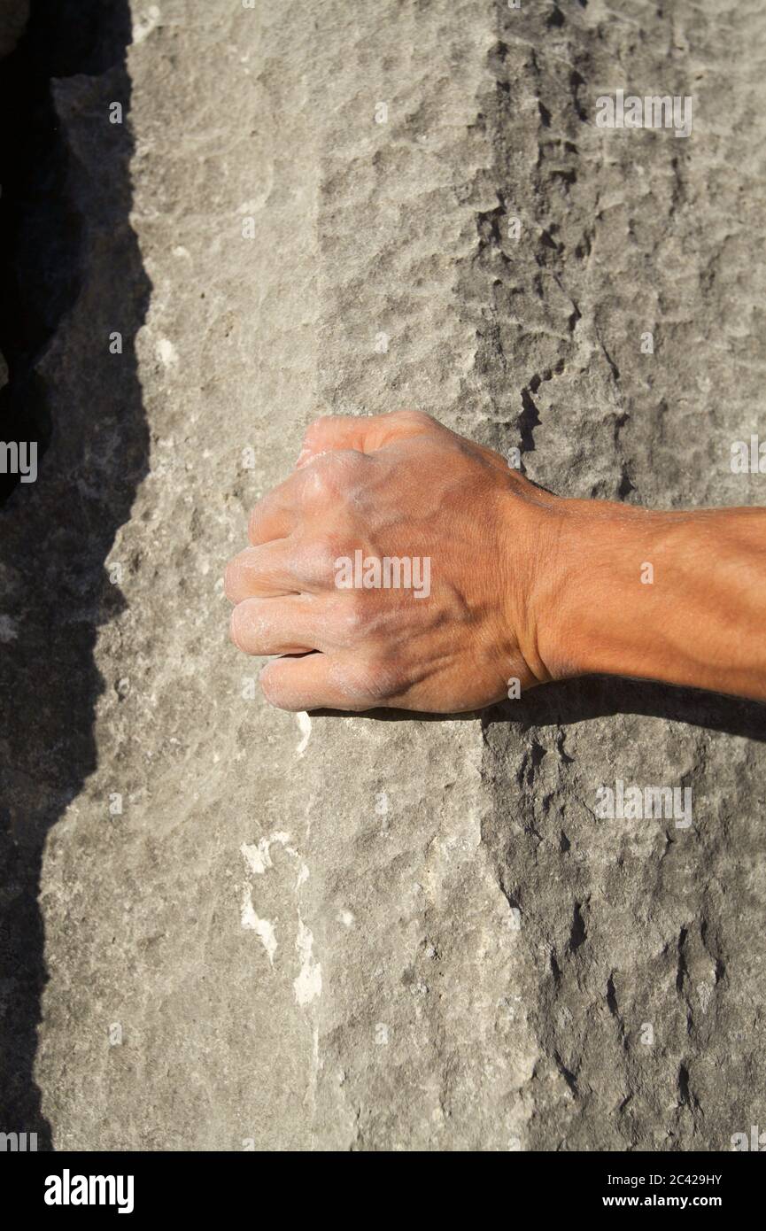 Hand touches a rock - strength - climbing Stock Photo - Alamy