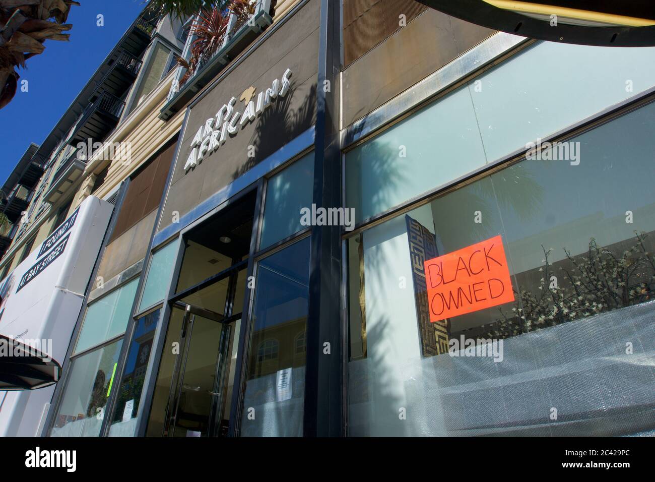 Black owned business with sign in storefront window. The store avoided looting damage after the death of George Floyd and BLM protests. Emeryville, CA Stock Photo