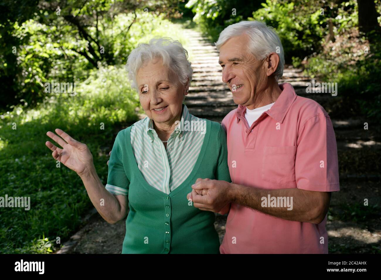 Retired couple goes for a walk hand in hand Stock Photo