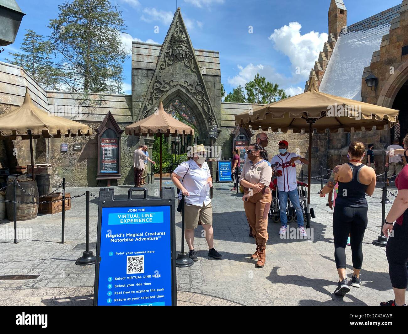 Orlando, FL/USA-6/13/20: The entrance to the Hagrid's Magical Creatures Ride at Wizarding World of Harry Potter with people wearing face masks. Stock Photo
