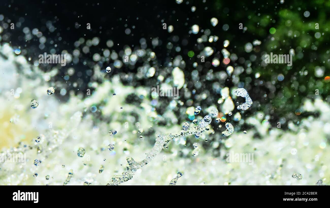 Water backgrounds with foam spray fast flow. The water in mad flows with droplets and whirlpools