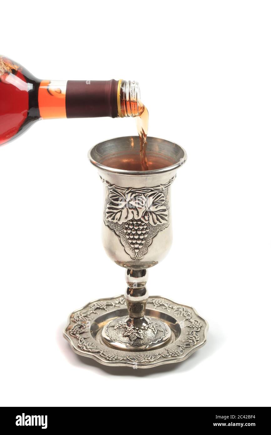 Wine poured into kiddush cup, isolated Stock Photo