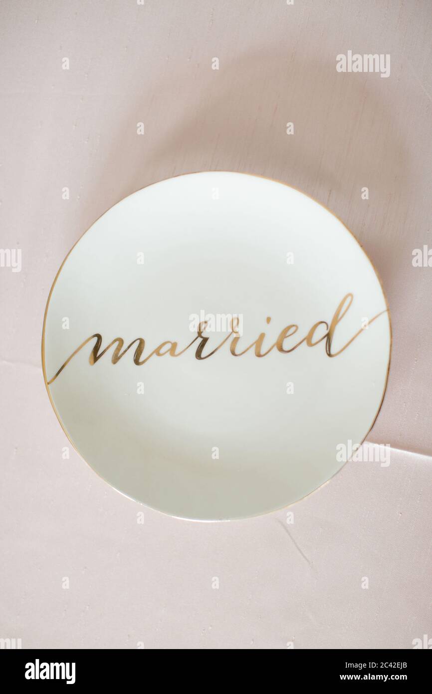 White plate with 'married' gold text Stock Photo