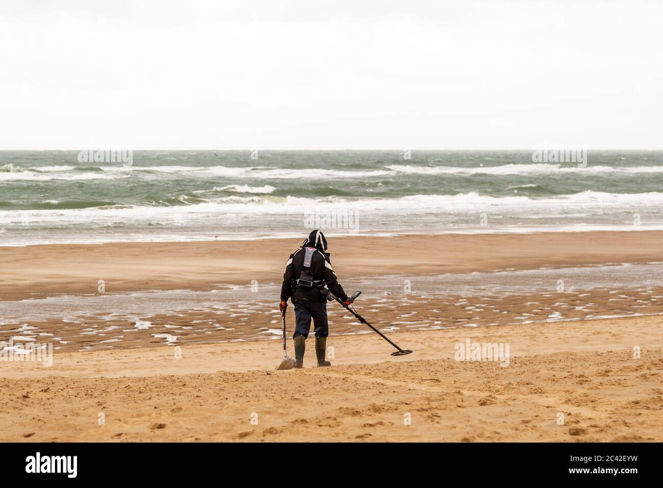 Beach walker with metal detector at Veere-Oostkapelle, The Netherlands Stock Photo