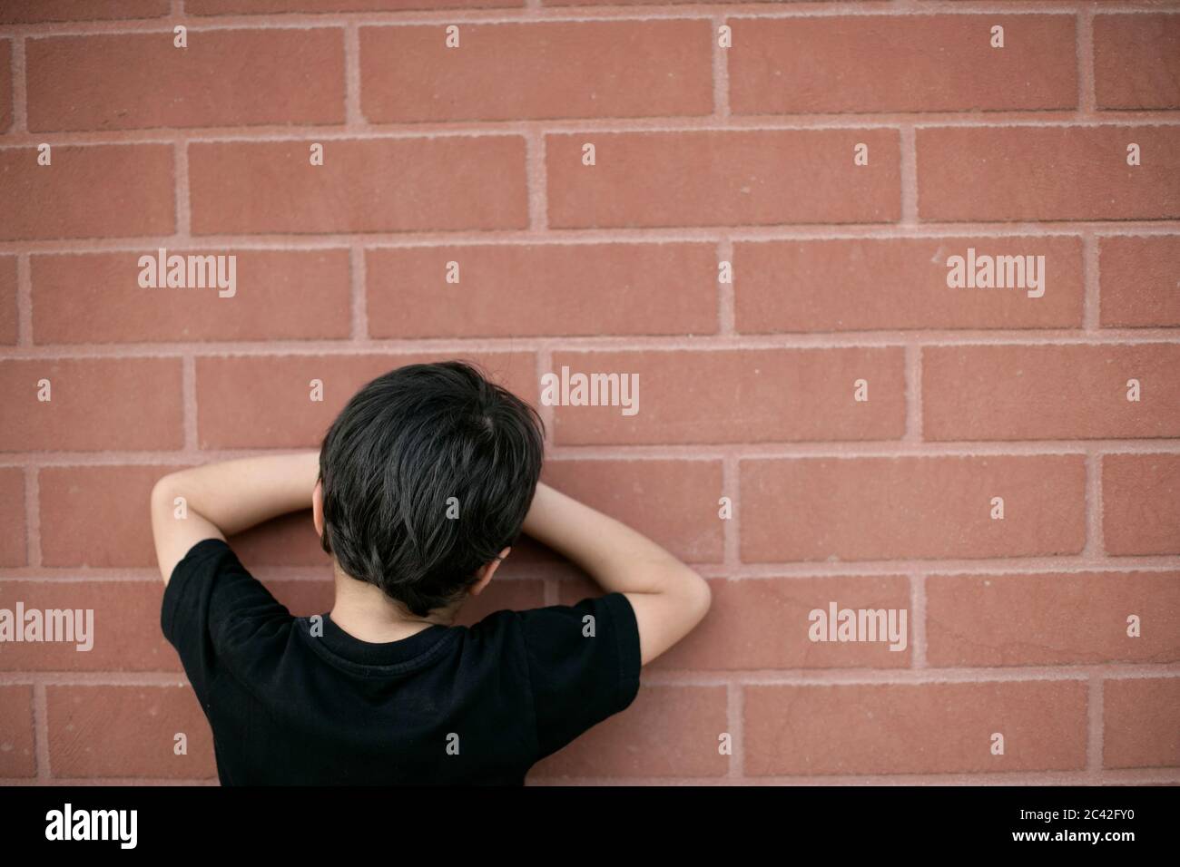 Little boy counts on the wall for hiding - youth - childhood Stock Photo