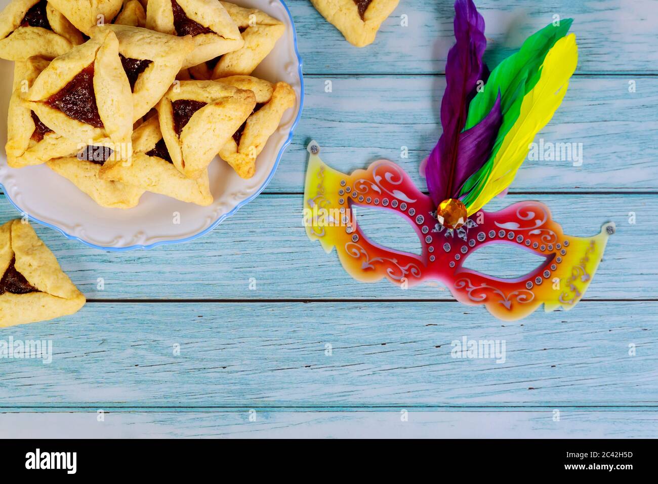 Purim background with mask and hamantaschen triangle cookies Stock