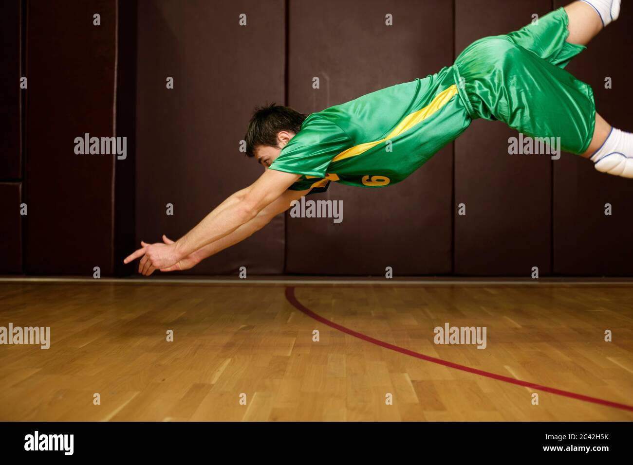 Volleyball player dives for a ball Stock Photo Alamy