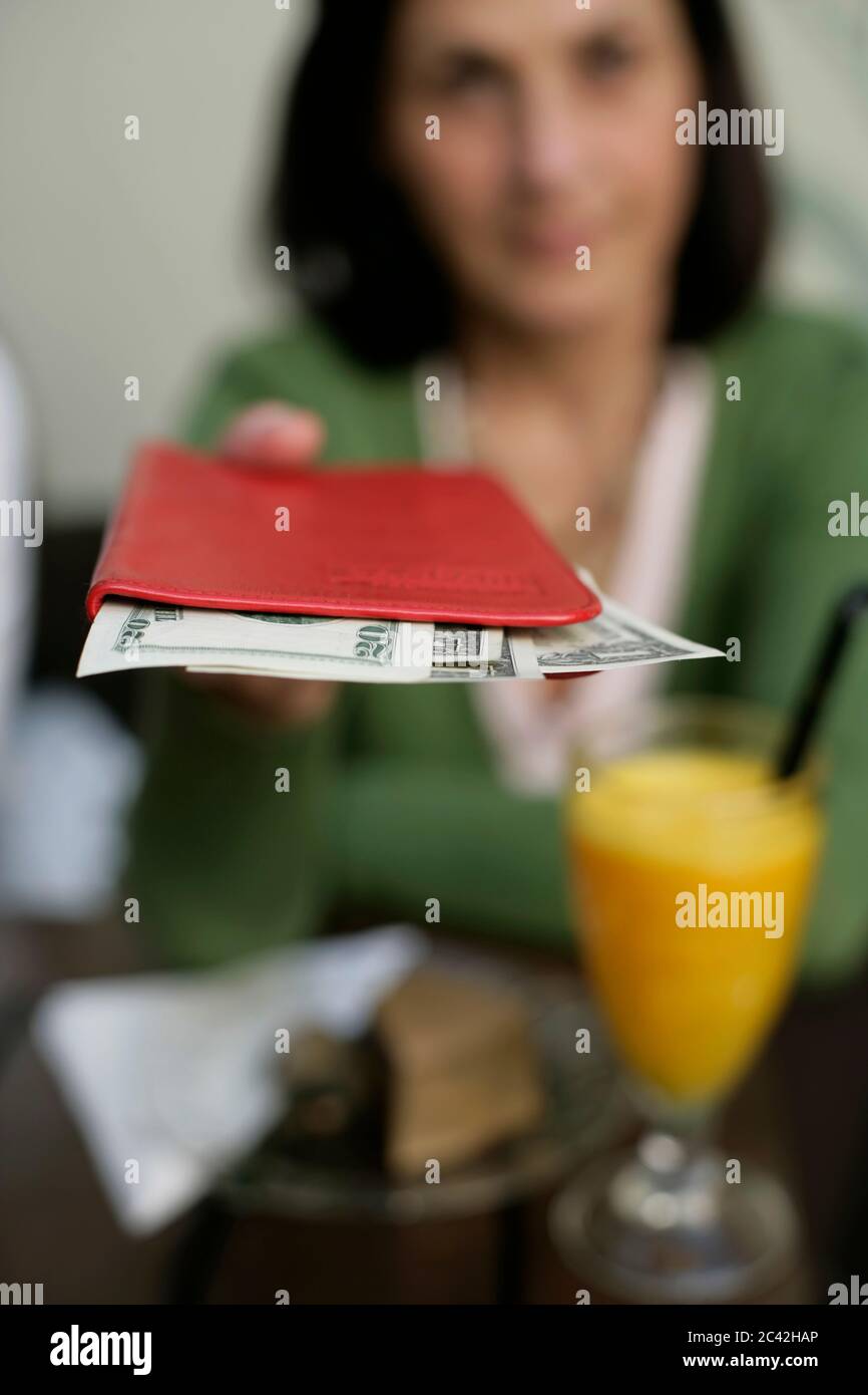 Elderly Woman Pays Bill In A Cafe Stock Photo Alamy