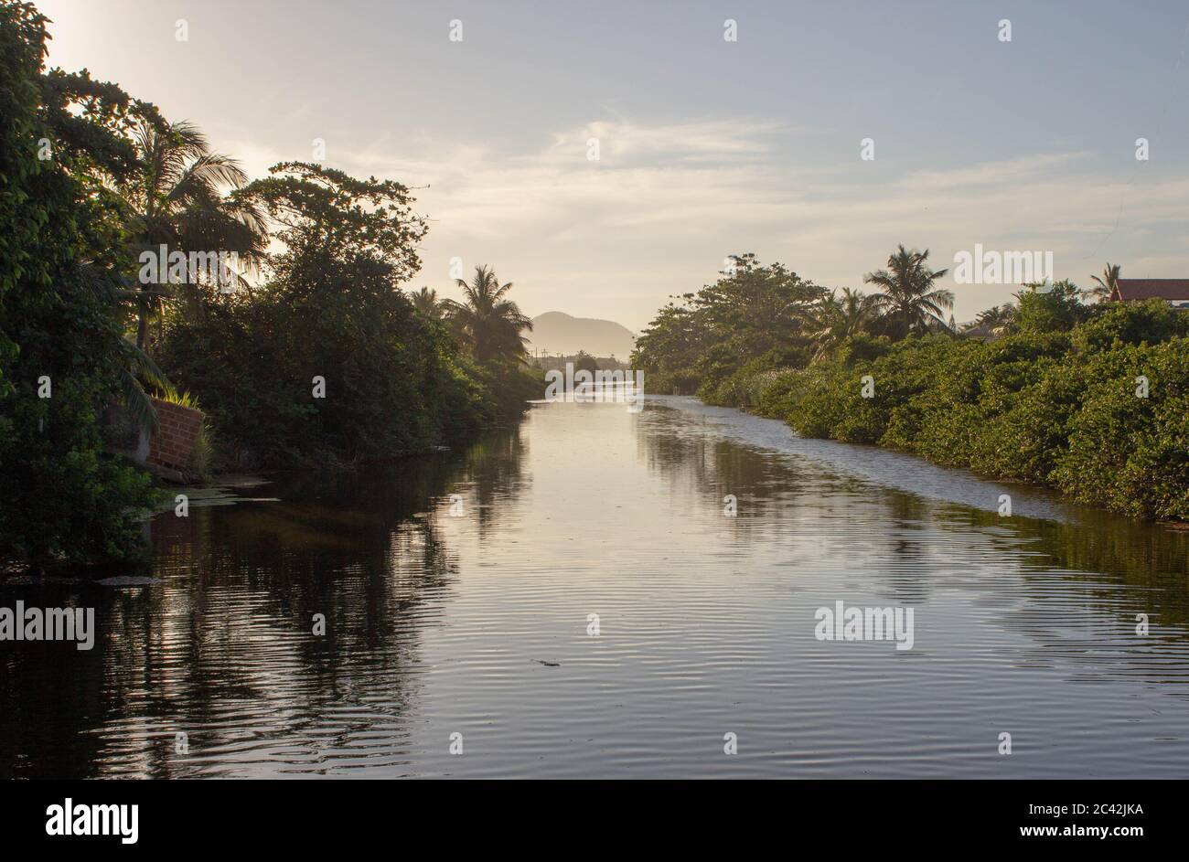 City canal of Itaipuaçu, Rio de Janeiro, during the sunset with beautiful reflexions on the water Stock Photo