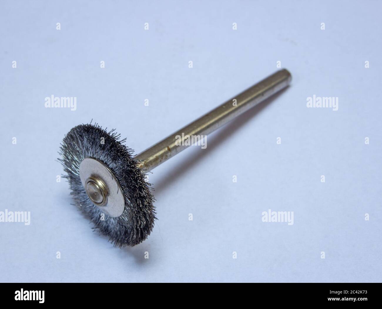 Steel brush used with rotary tools to clean metal surfaces Stock Photo