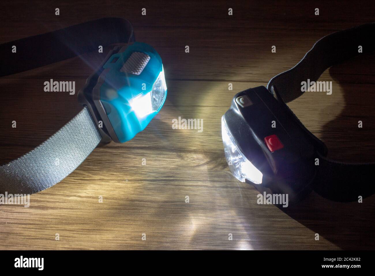 A pair of led headlamps turned on facing each other showing the light beams Stock Photo