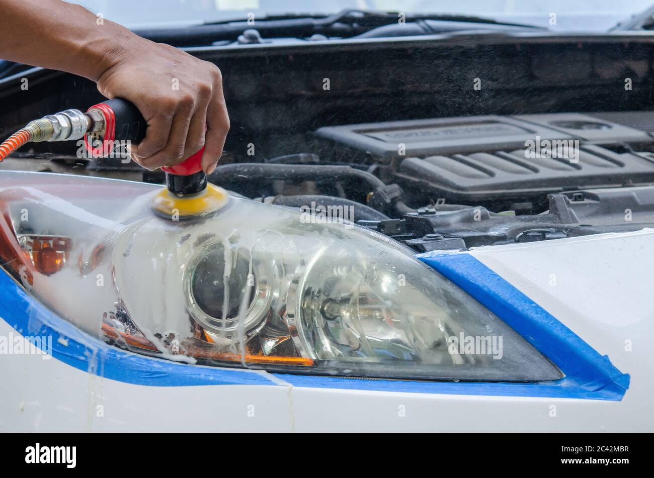 Car details Headlight cleaning with power polishing Stock Photo Alamy