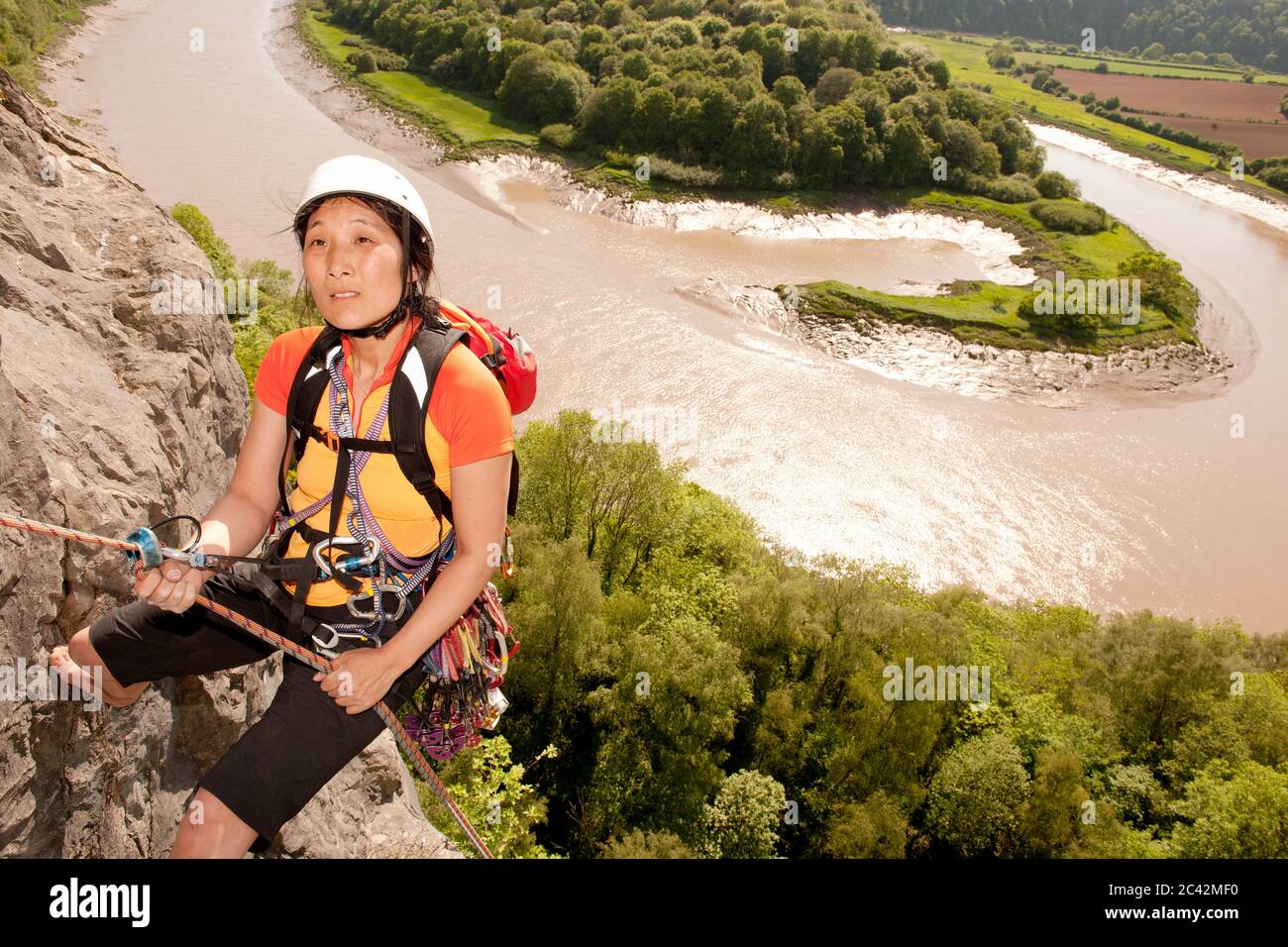 Woman rappelling of cliff in south Wales Stock Photo - Alamy