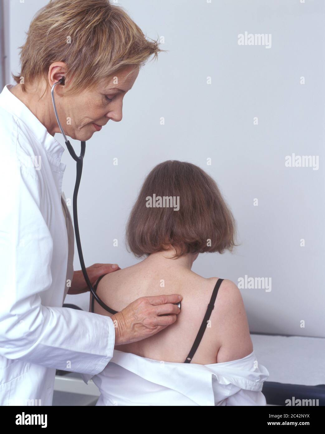 Doctor listens to a patient's lungs - st…