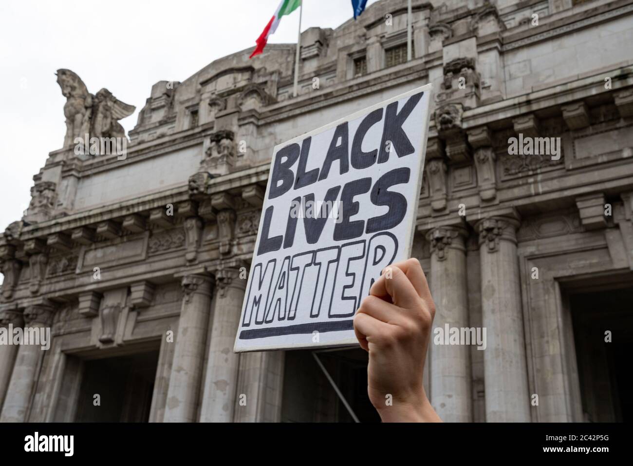 Hand of a young protester holding a sign with the words:'Black Lives Matter' during the protest assembly in solidarity to BLM movement. Milan Central Stock Photo