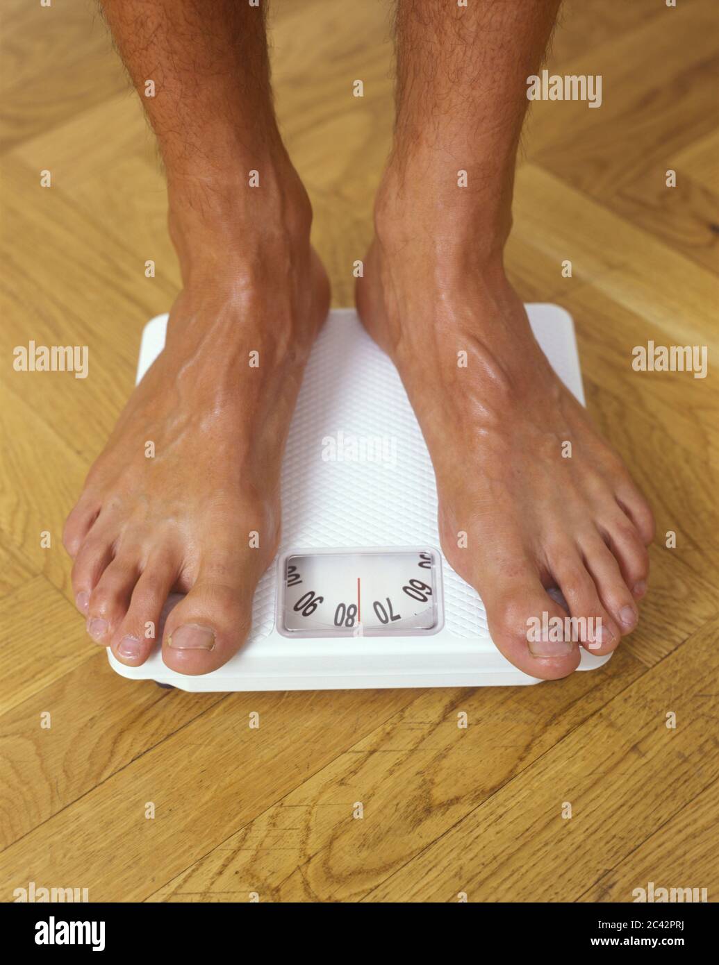 Men's feet on scales Stock Photo Alamy