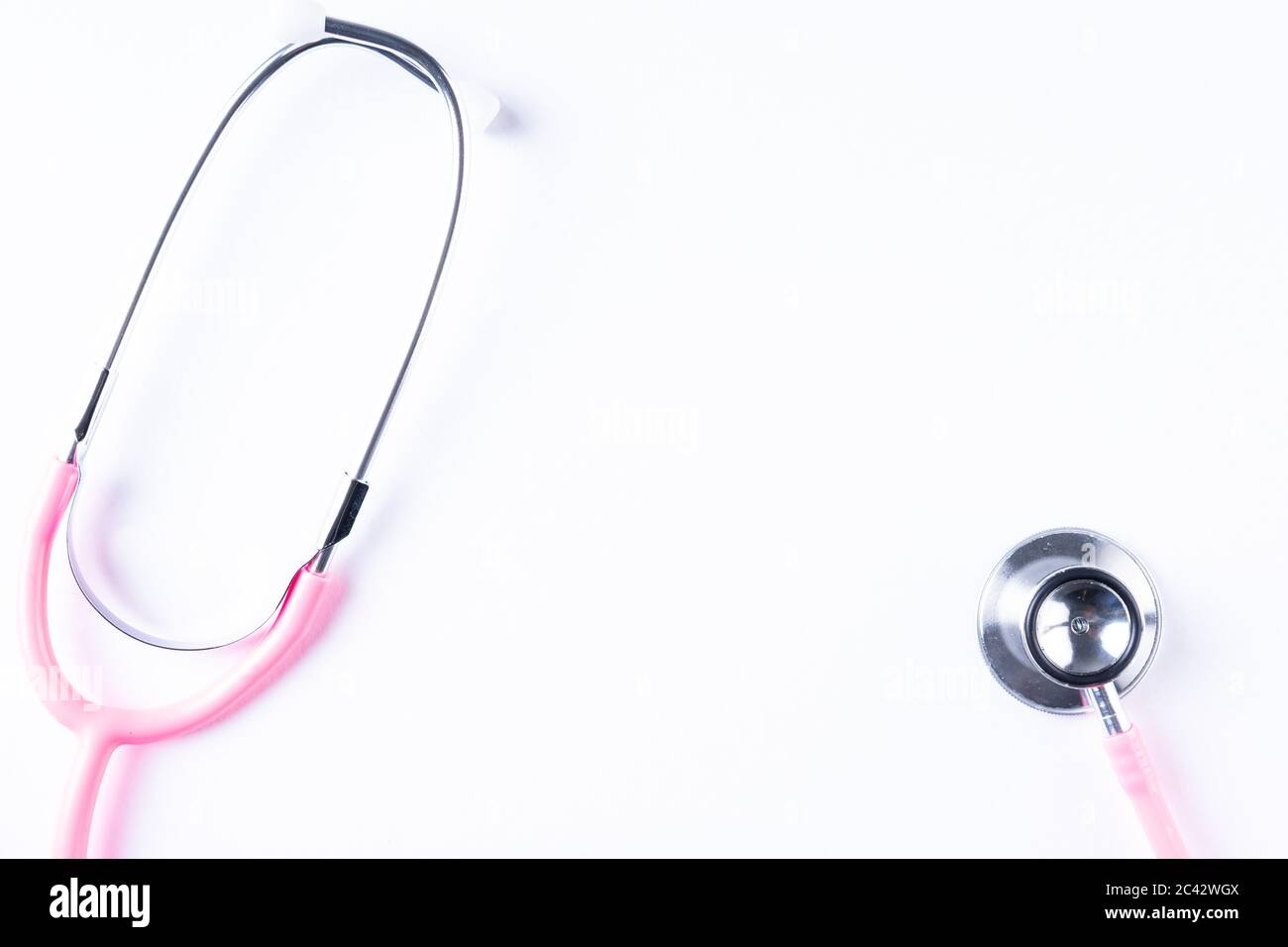 Pink stethoscope isolated on white with copy space for text Stock Photo ...