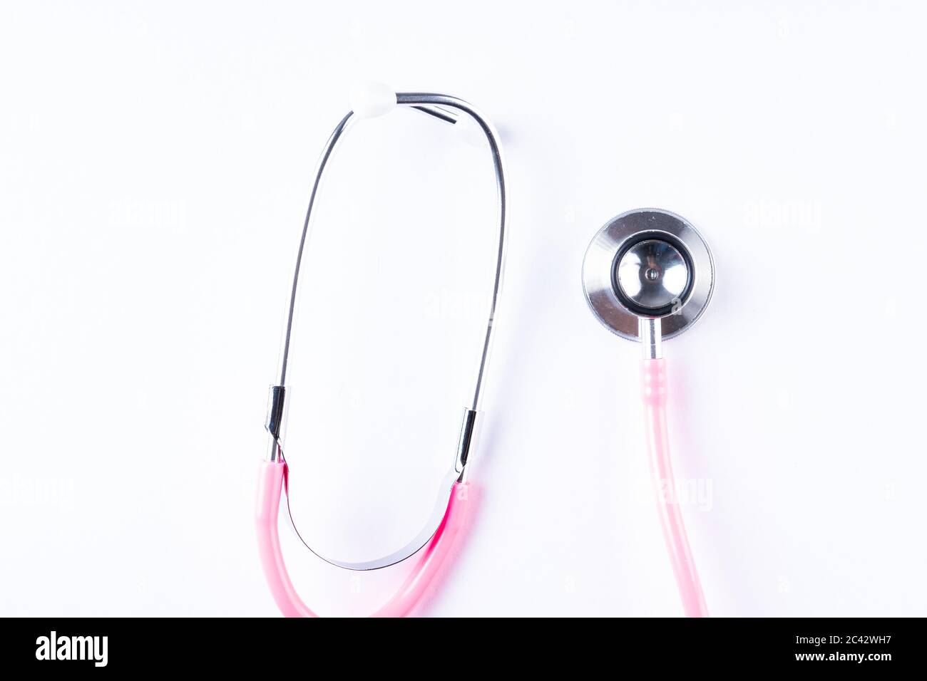 Pink stethoscope isolated on white with copy space for text Stock Photo ...
