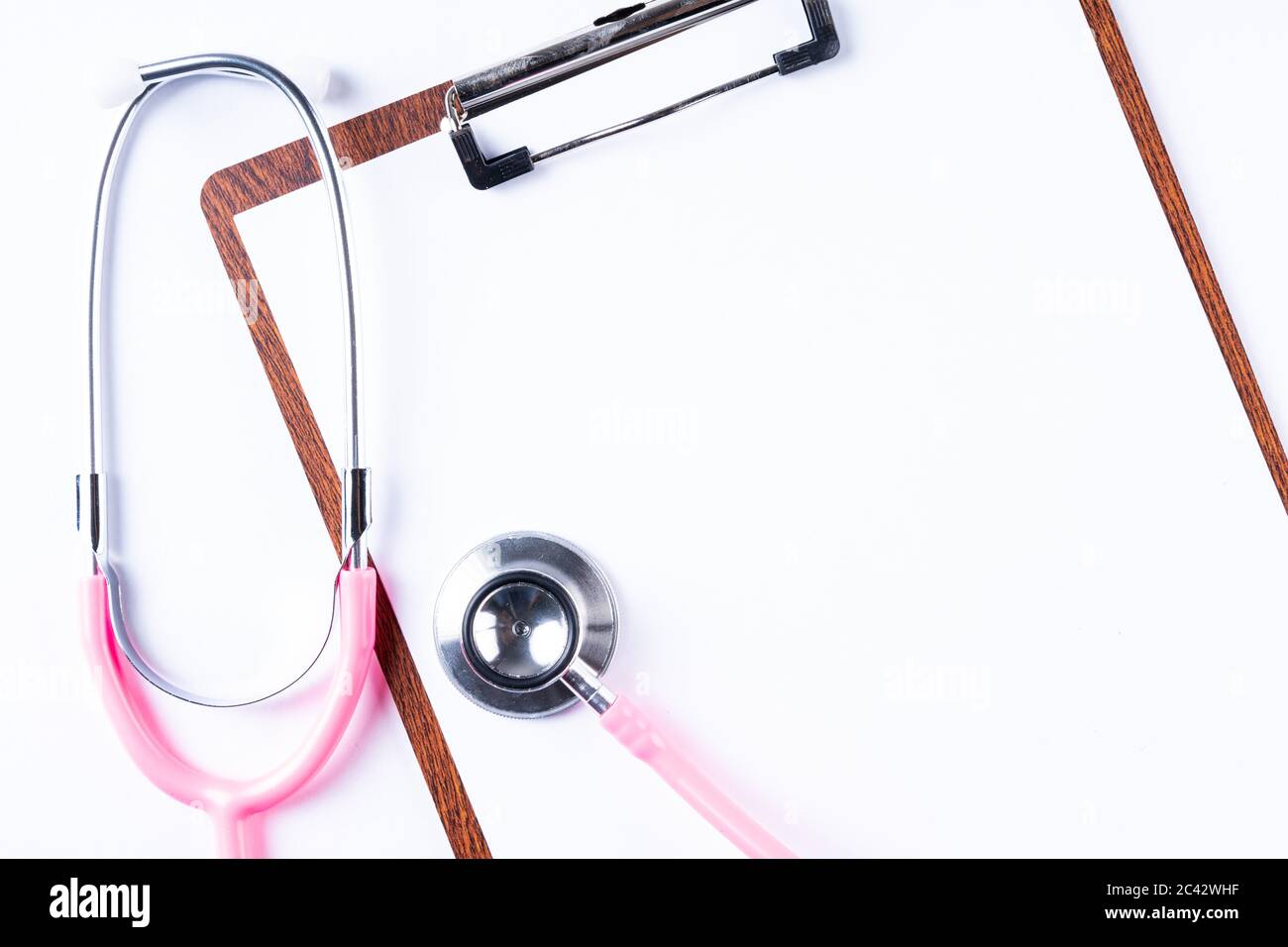 Pink stethoscope isolated on white with copy space for text Stock Photo ...