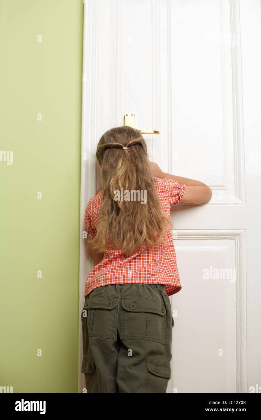 Girl (5 years old) stands at a door Stock Photo