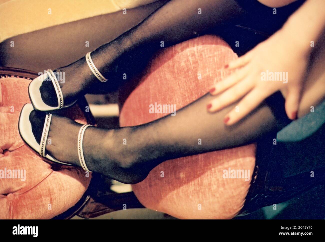 Women's legs on chair Stock Photo Alamy