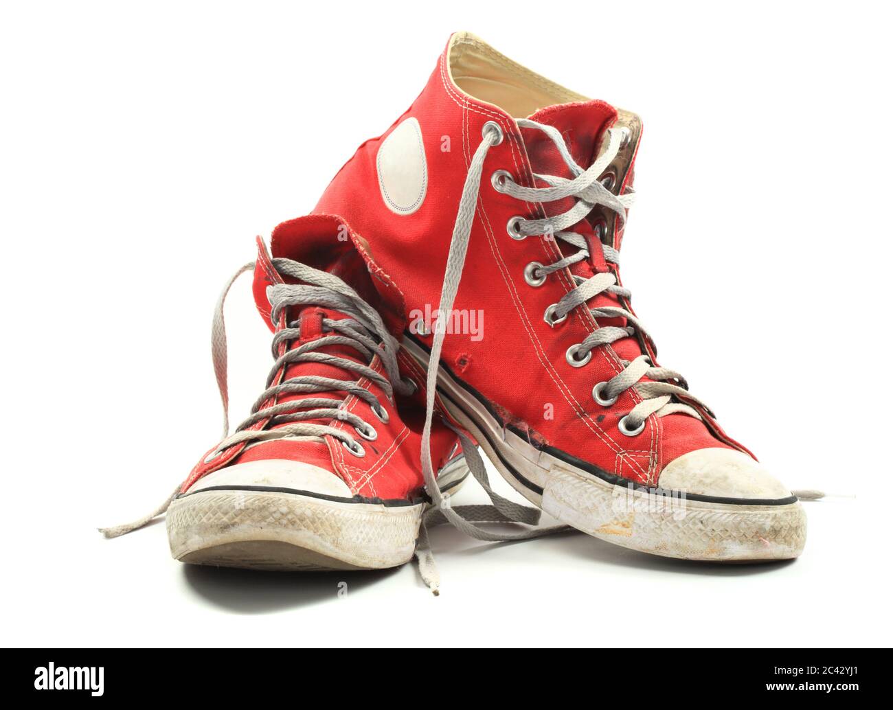 Old and dirty red canvas sneakers, isolated over white Stock Photo - Alamy