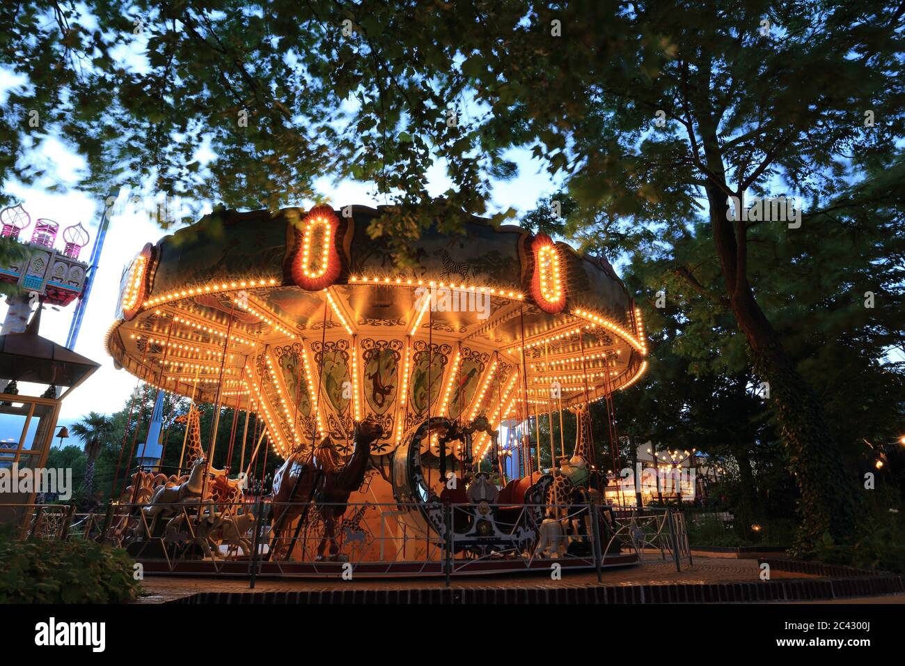 Copenhagen, Denmark - June 29, 2014: Classic Carousel in Tivoli amusement park. Almost 4 million people visit Tivoli Gardens each year. Stock Photo