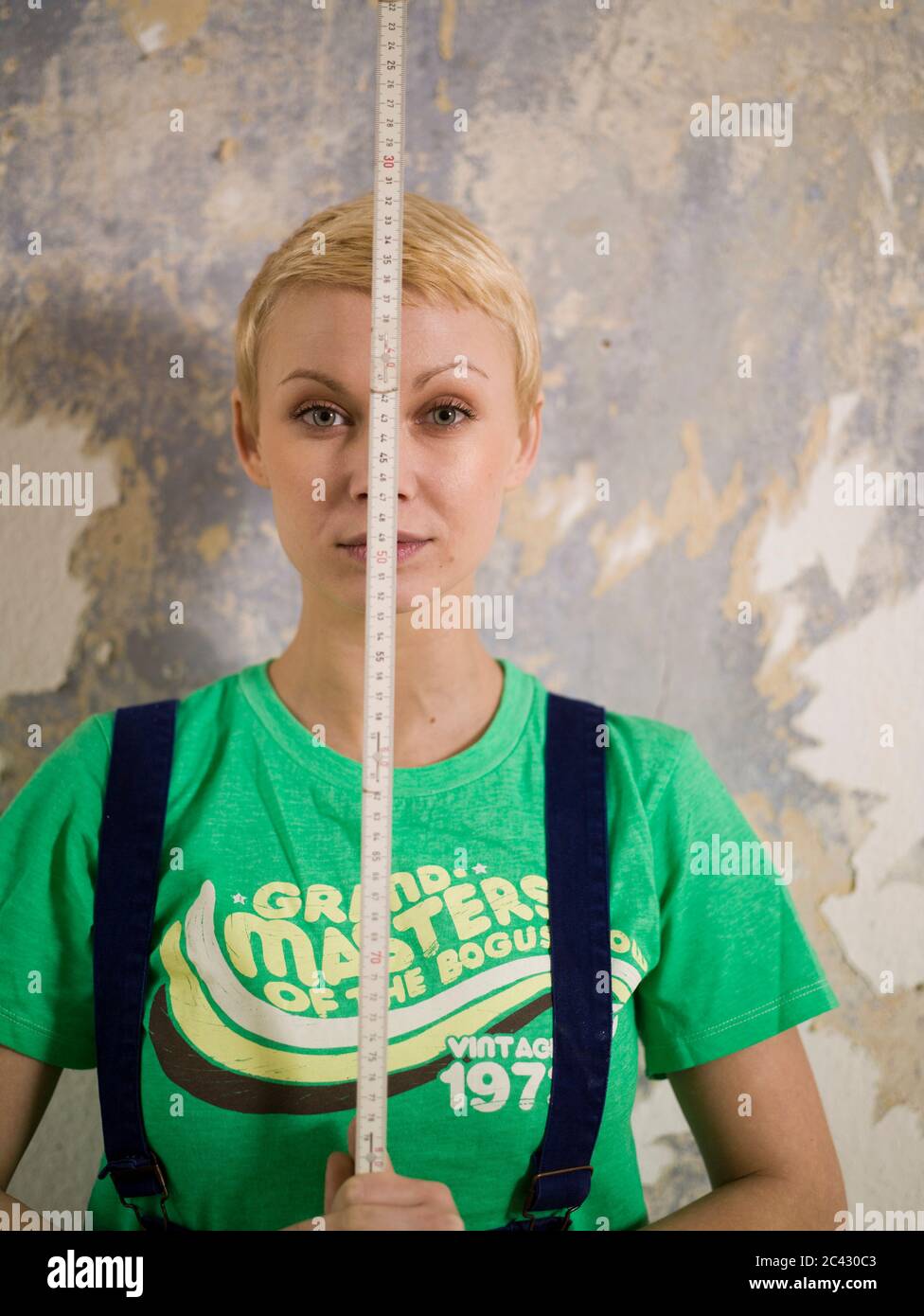 Young man holding folding rule hi-res stock photography and images - Alamy