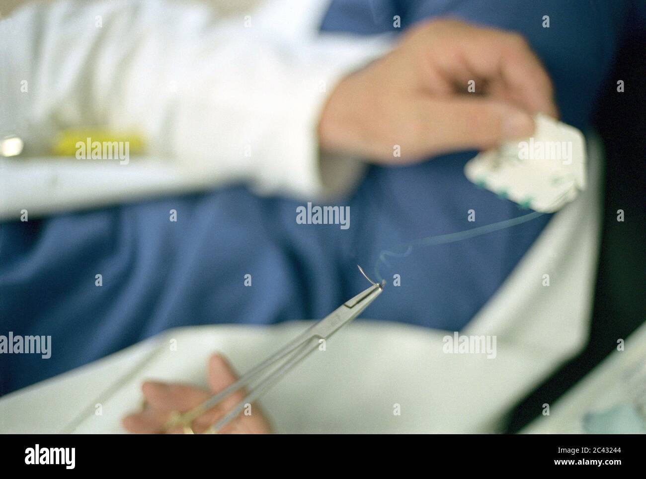 Doctor with surgical sewing kit (detail) - hospital Stock Photo
