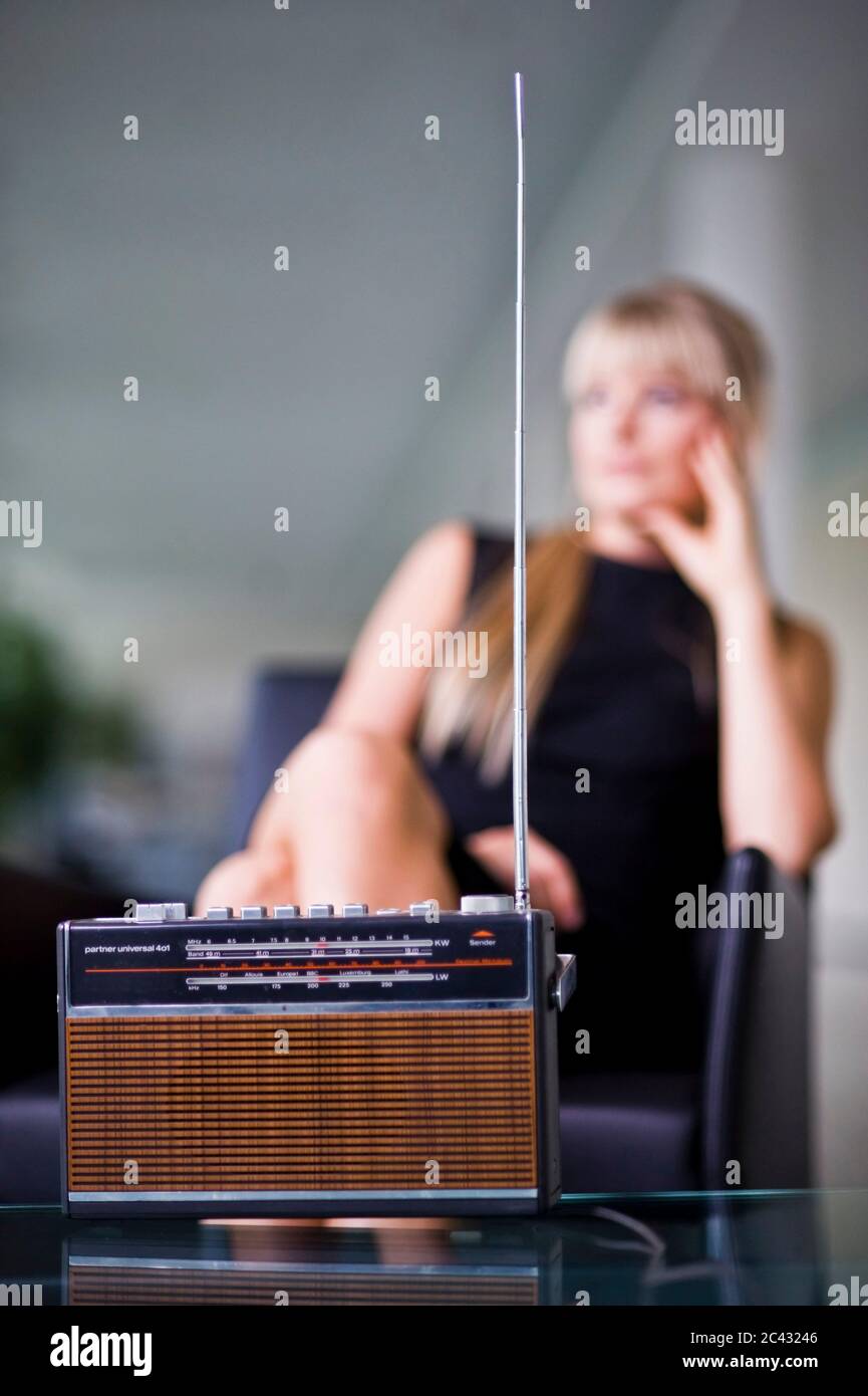 Old portable radio, young woman sitting in the background, Munich, Bavaria,  Germany Stock Photo - Alamy