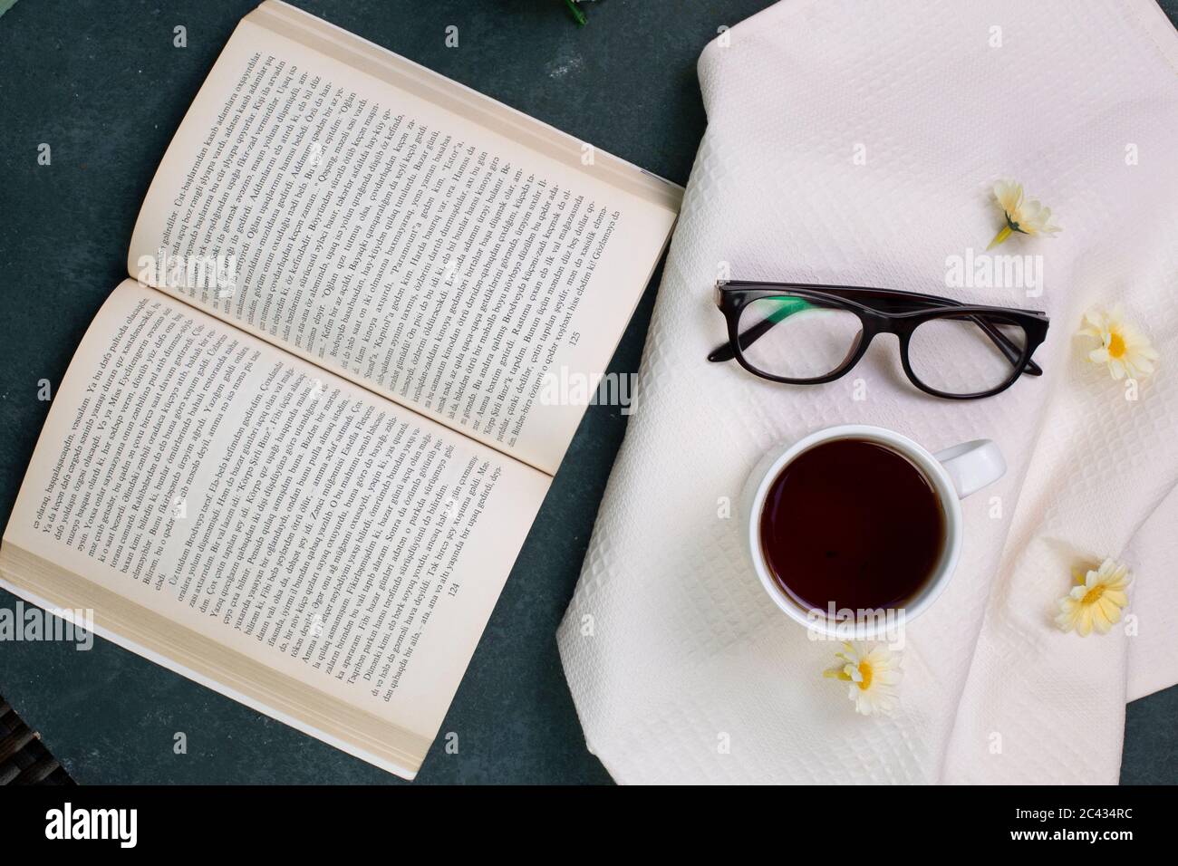 A cup of tea, optique glasses and a book, top view Stock Photo