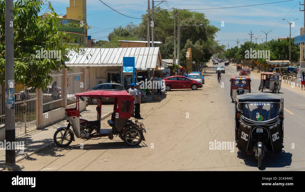 Zorritos, Piura / Peru - April 7 2019: Mototaxis circulating on the main road in the town of Zorritos Stock Photo