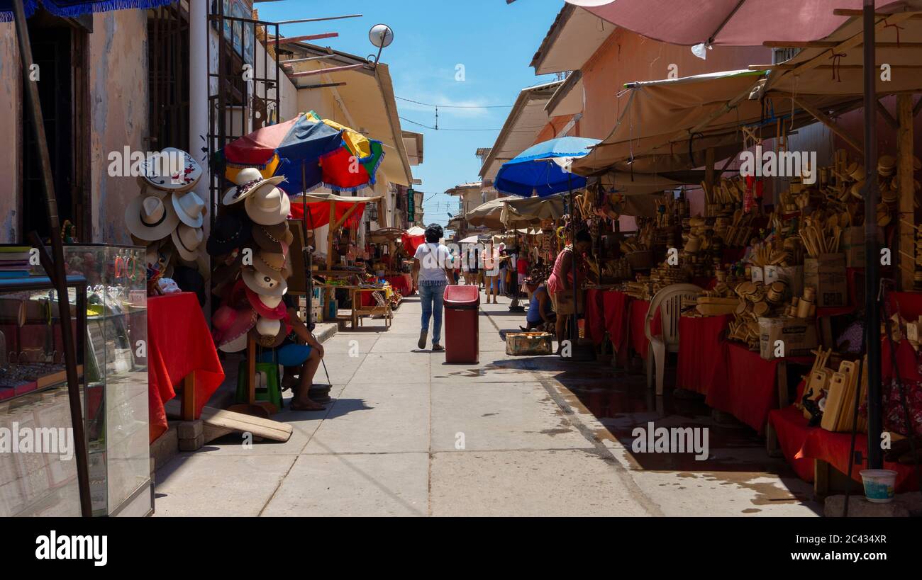 Catacaos, Piura / Peru - April 6 2019: Tourists walking on a street full of craft vendors in the center of town of Catacaos Stock Photo