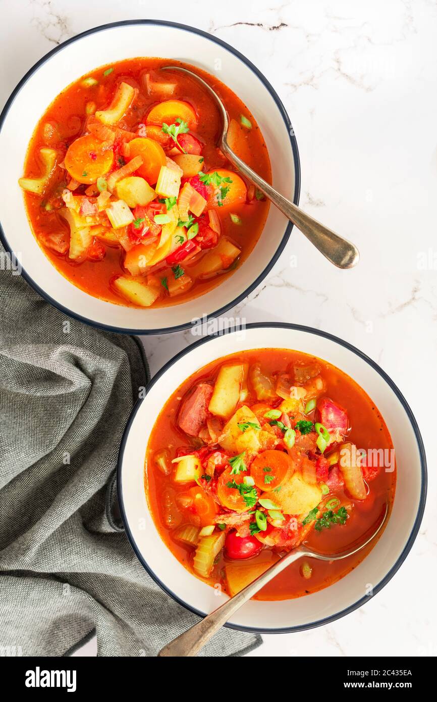 Tomato and vegetable soup with ham hock. Stock Photo