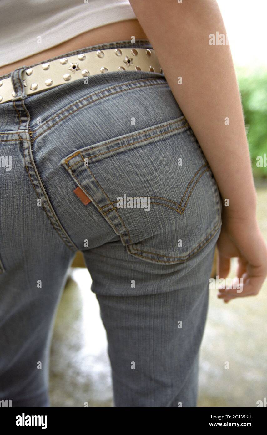 Young woman in jeans with a studded belt - trend - curves Stock Photo -  Alamy