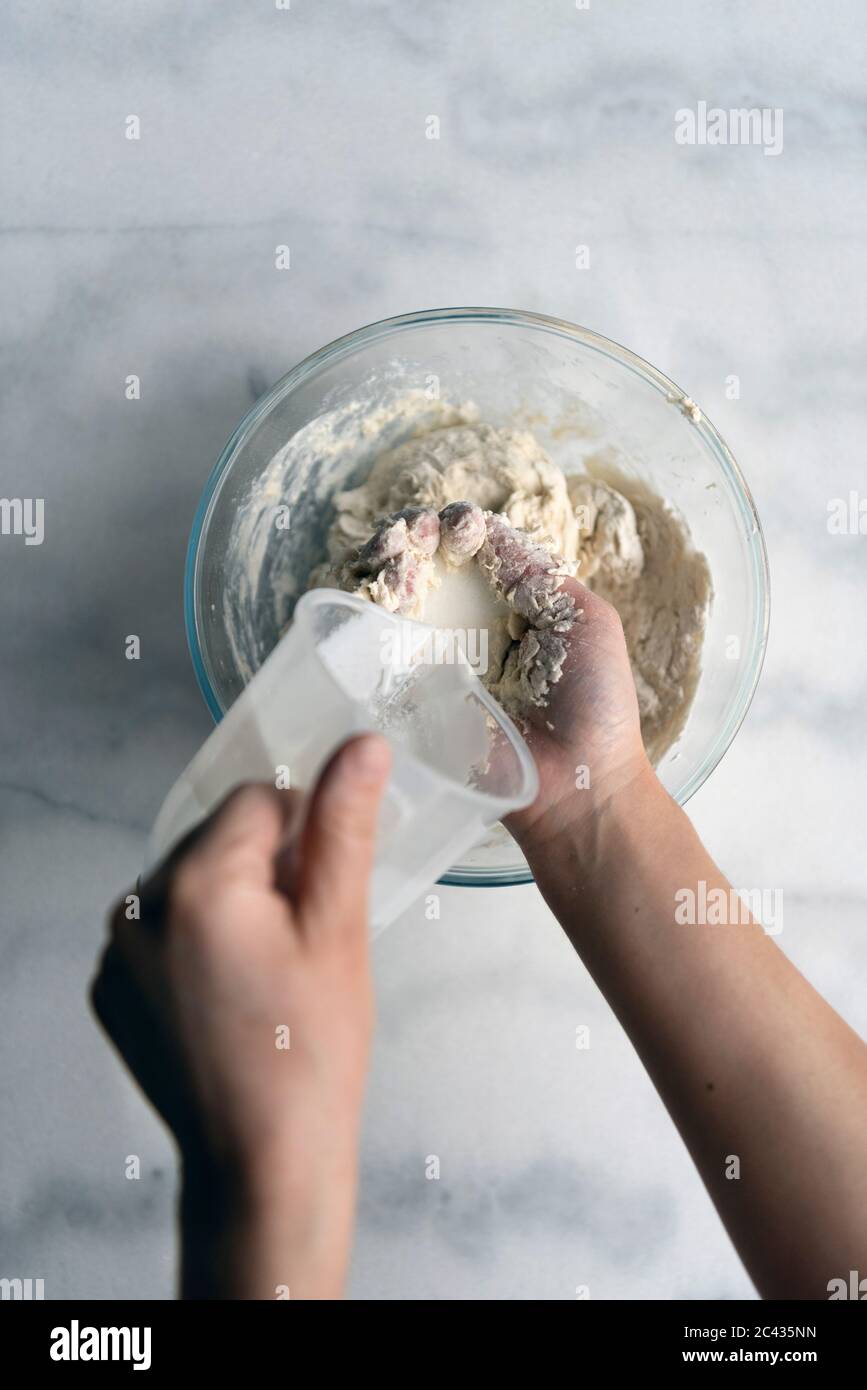 https://c8.alamy.com/comp/2C435NN/hands-making-bread-dough-without-yeast-in-a-glass-mixing-bowl-2C435NN.jpg