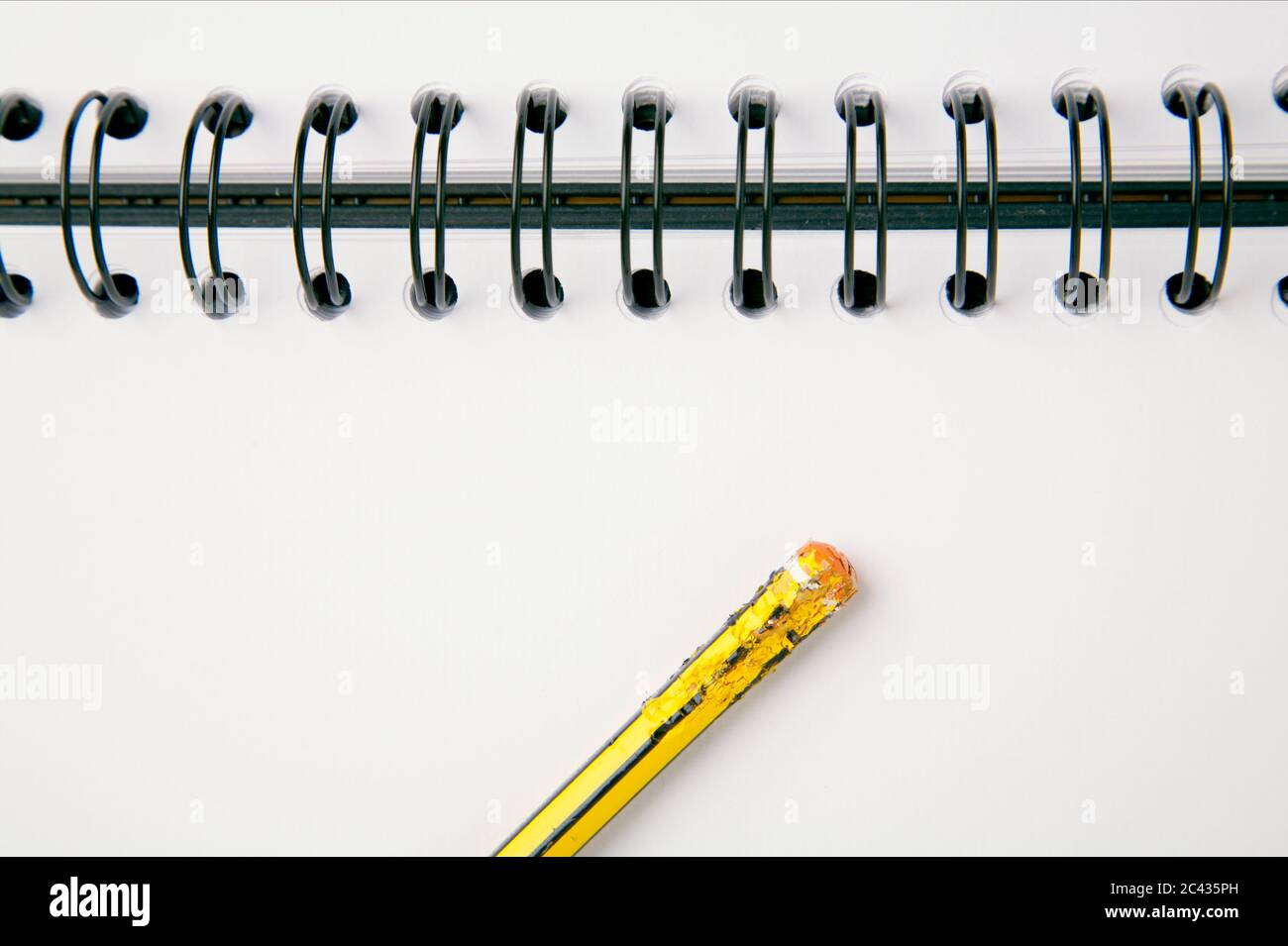 Spiral notebook and a chewed pencil, close-up Stock Photo