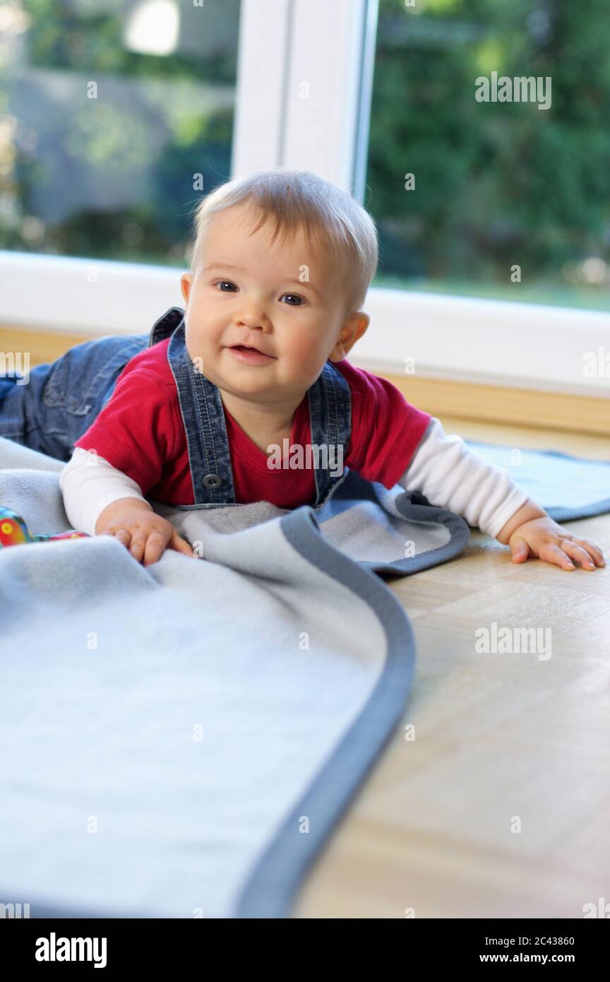 Baby is lying on her stomach Stock Photo Alamy