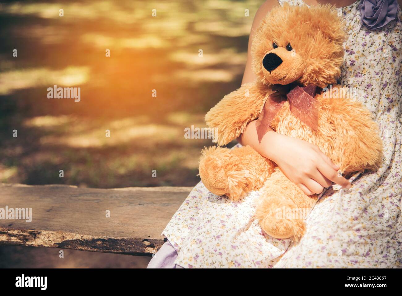 Sad girl feeling alone in the park. Lonely concepts. Beautiful toddler girl  and fluffy stay alone under the big tree Stock Photo - Alamy