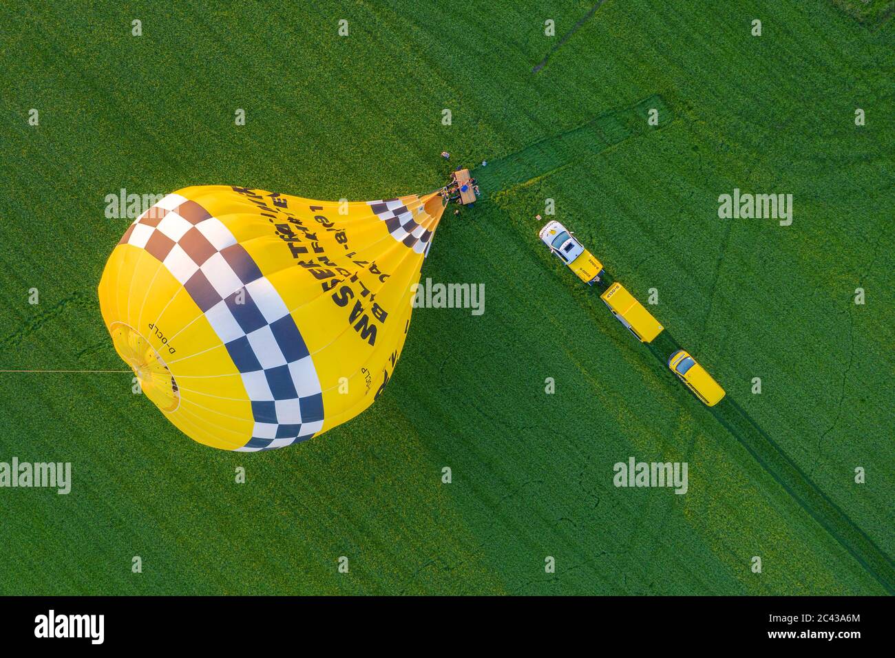 Cloppenburg, Germany. 23rd June, 2020. The band 'Crackerjacks' landed on a pasture with a hot-air balloon after they had held a balloon concert over the town of Cloppenburg. (Recording with a drone) Credit: Mohssen Assanimoghaddam/dpa/Alamy Live News Stock Photo
