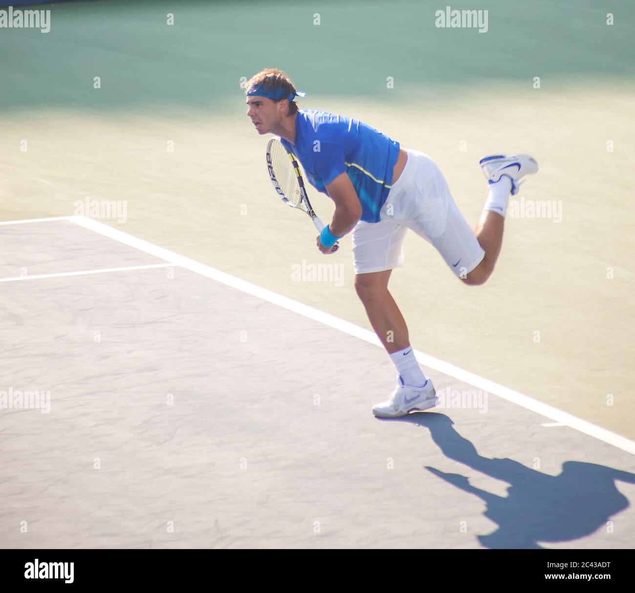 Rafael Nadal following through on serving at the US Tennis Open Final at Flushing Meadows, New York, USA, 2011 Stock Photo