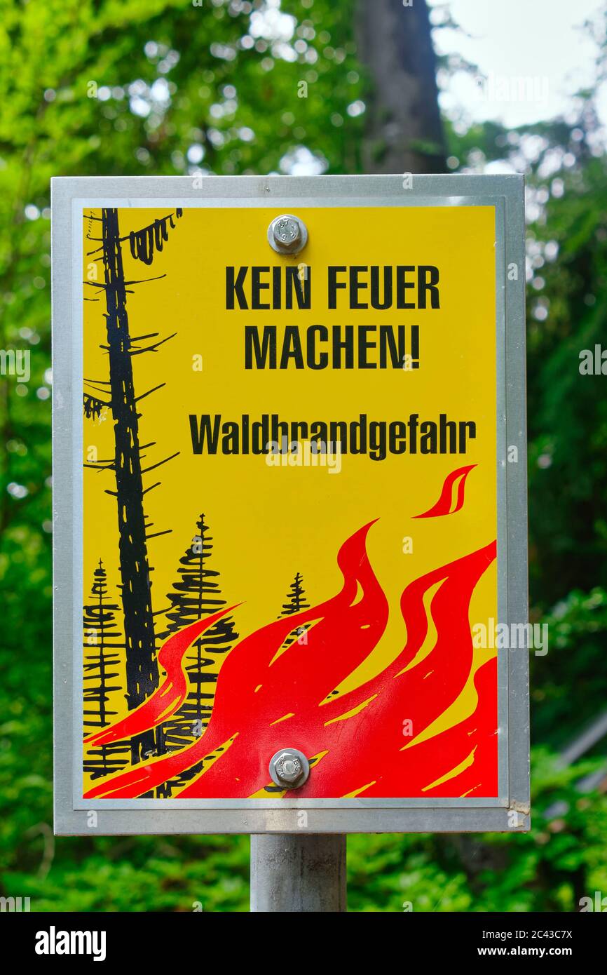 Swiss warning sign which prohibits open fires, with the following text: Do not light a fire! Risk of forest fire. Stock Photo