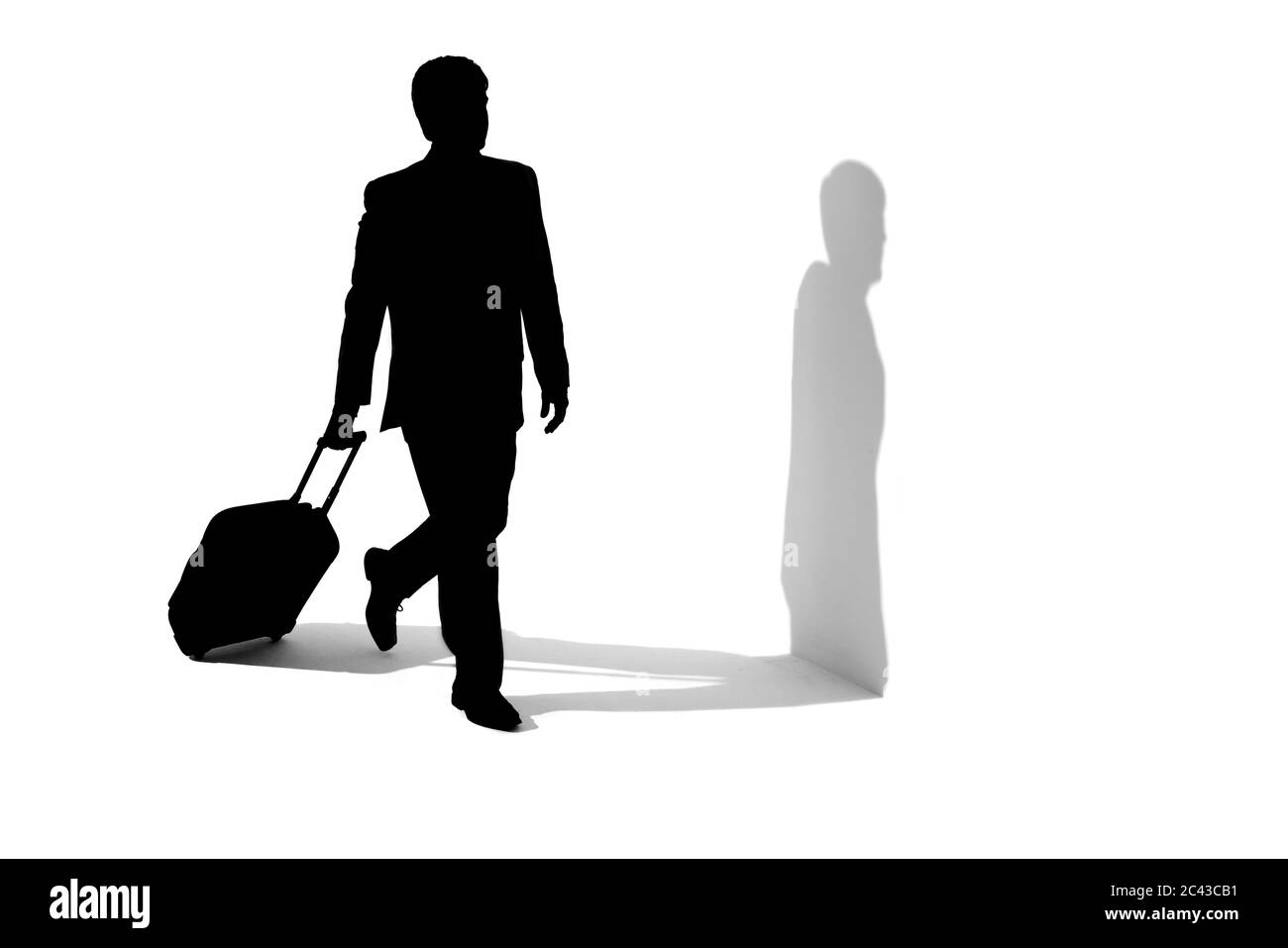 Silhouette of a man with a suitcase Stock Photo - Alamy