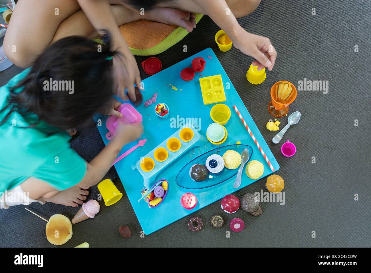 Asian young mom stay at home play with plasticine modeling clay with little daughter, happy mother and cute girl have fun engaged in creative activity Stock Photo