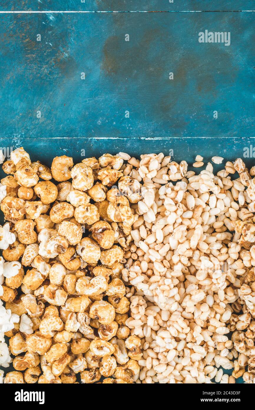 Popcorn and wheat corns on a blue background Stock Photo Alamy