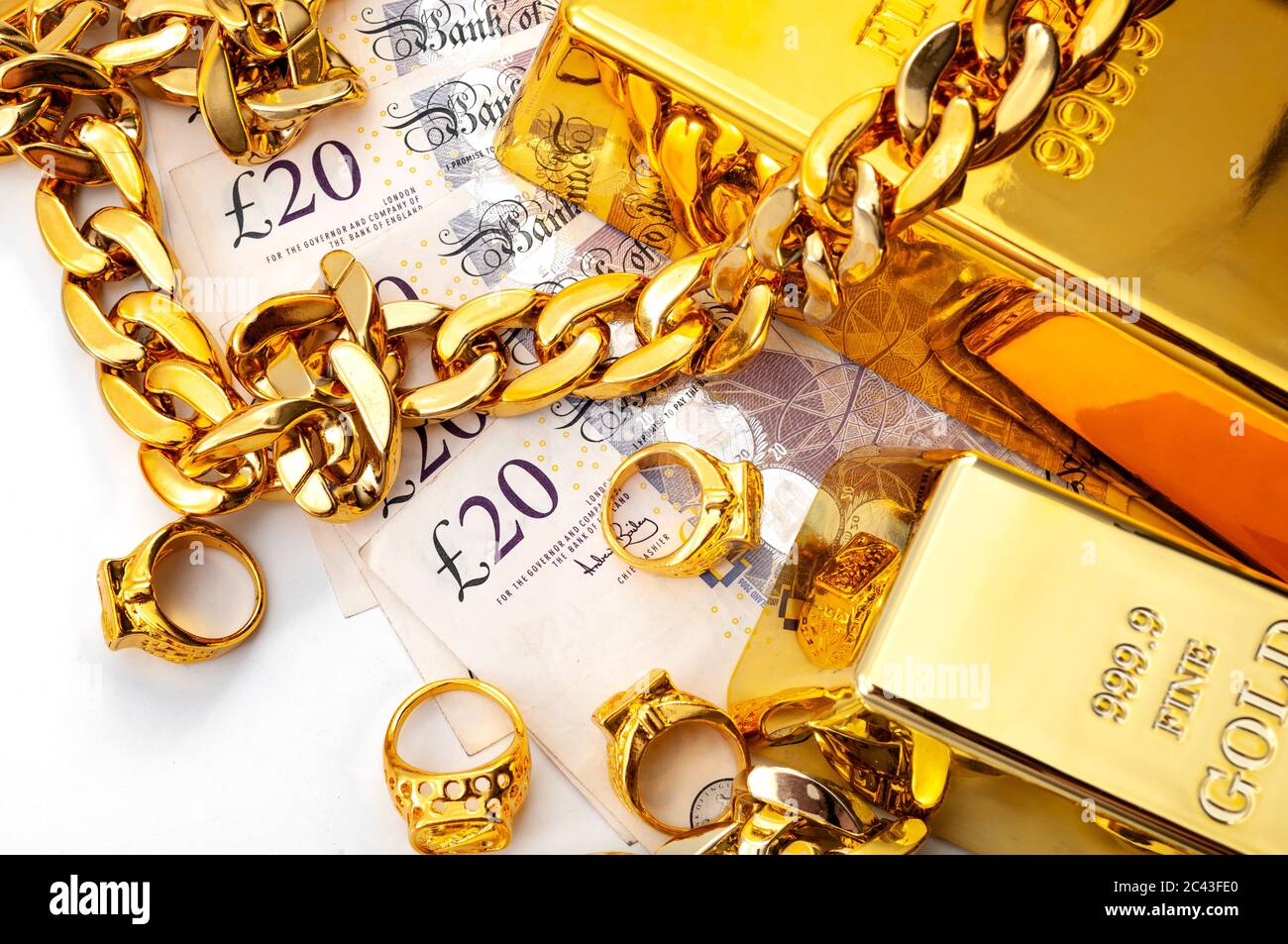 Jewelry buyer, pawn shop and buy and sell precious metals concept theme with pile of cash in british pounds, golden rings, necklace bracelet and gold Stock Photo