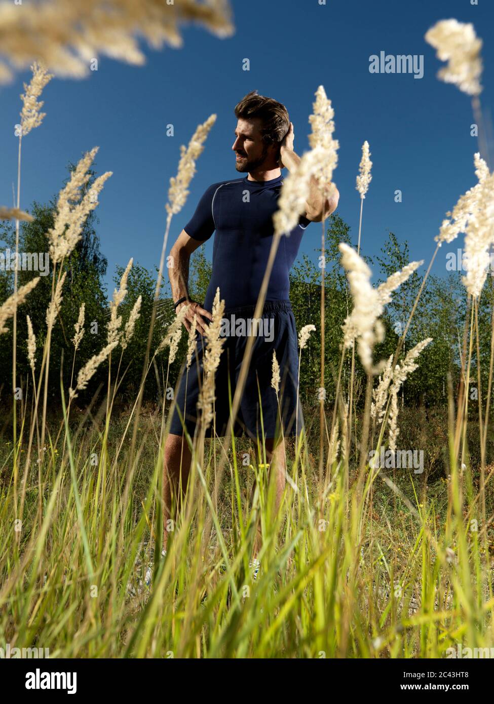 Jogger stands in a rural area, Munich, Bavaria, Germany Stock Photo