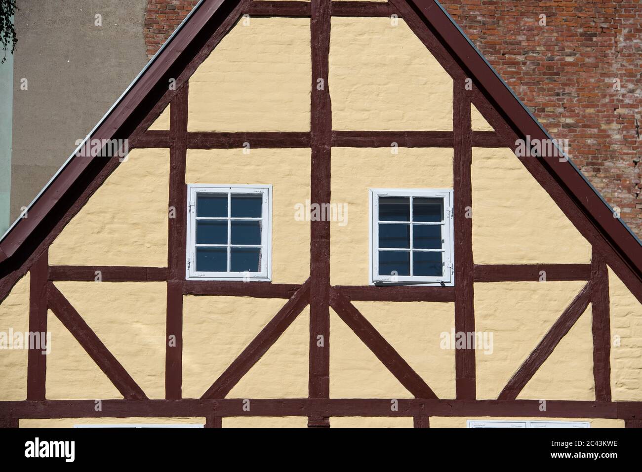 15 June 2020, Mecklenburg-Western Pomerania, Stralsund: Half-timbered houses in the monastery courtyard of the former Franciscan monastery St. Johannis (Johanniskloster) in the old town of Stralsund. The Hanseatic city of Stralsund, first mentioned in 1234, is one of the tourist magnets in Mecklenburg-Vorpommern because of the more than 500 listed buildings, most of which have been extensively restored in recent years with the trustee redevelopment company Stadterneuerungsgesellschaft Stralsund mbH (SES). In June 2002, the medieval old town centre of Stralsund was included in the UNESCO list o Stock Photo
